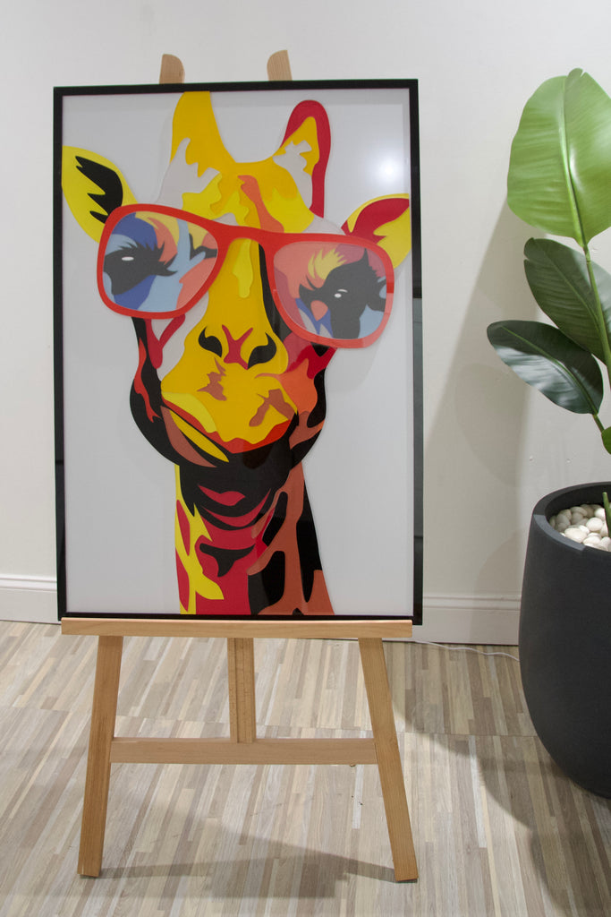 Colorful acrylic wall art featuring a giraffe with red glasses, perfect for modern home decor.
